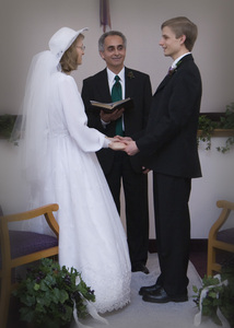 Saying the vows to each other.